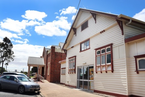 The front of a wooden building and footpath