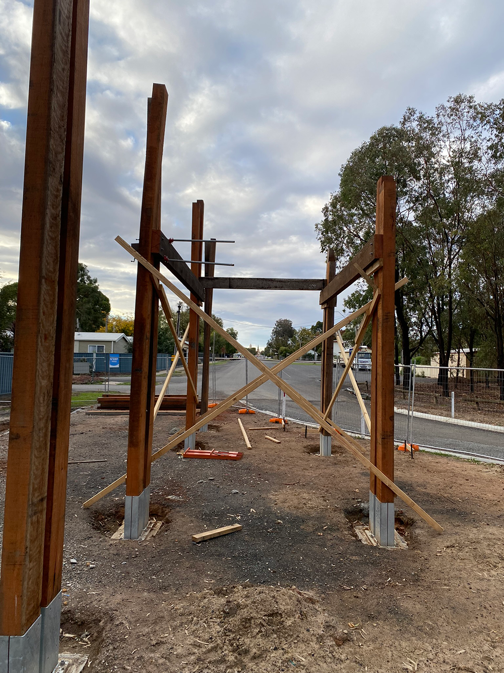 Riverfront entrance pergola under construction.png