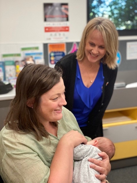 Midwife Jenny Bull (back) with a mother and baby.jpg